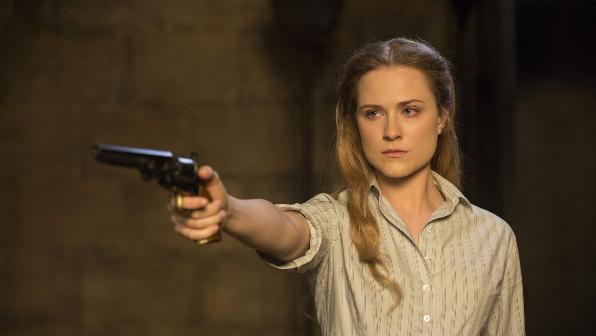 A young woman scowls and takes aim with her pistol.