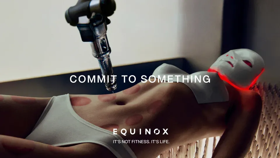 This image appears as it does in an actual Equinox ad, with the text COMMIT TO SOMETHING overlaid. I do not know what we are actually looking at, but it appears to be a cis woman enduring numerous beauty treatments and plastic surgeries simultaneously.